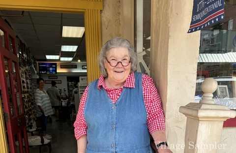 Pat in front of shop